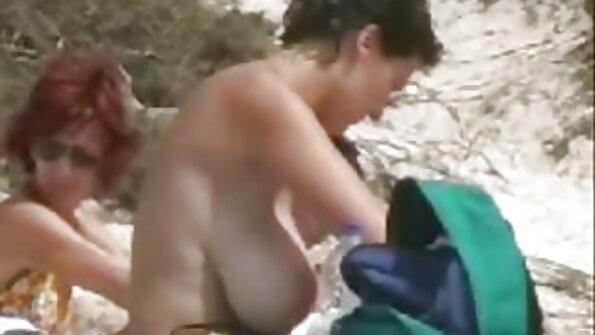 A raven haired woman is getting oil over her ass while outdoor